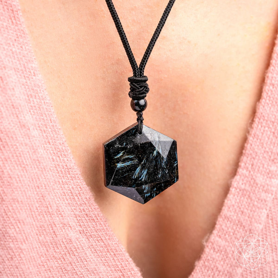 Deep healing Arfvedsonite necklace by Conscious Items featuring a polished pendant on a black cord.
