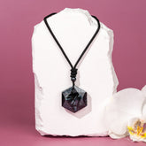 Deep healing Arfvedsonite pendant necklace by Conscious Items featuring a polished, oval-shaped gemstone on a sleek chain.