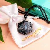 Deep healing Arfvedsonite pendant necklace by Conscious Items featuring a polished gemstone pendant on a delicate chain.