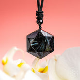 Deep healing Arfvedsonite pendant on a necklace from Conscious Items, featuring a polished stone with intricate natural patterns.