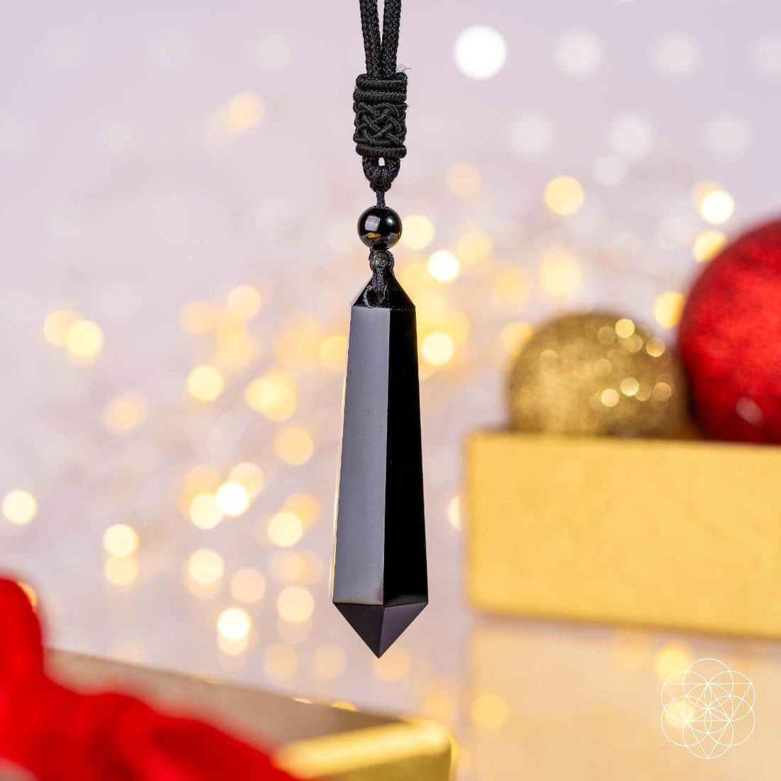 Black obsidian pendant necklace featuring the Obsidian Talisman of Protection by Conscious Items, showcasing a sleek, polished black stone.