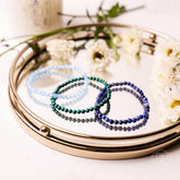 Set of chakra-balancing bracelets from Conscious Items, featuring colorful beads representing each of the seven chakras.