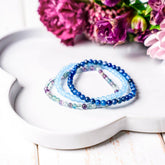 Set of chakra-balancing bracelets by Conscious Items, featuring colorful beads representing each chakra, for spiritual jewelry.