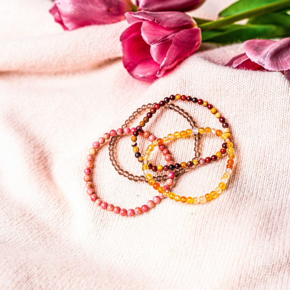 Set of chakra-balancing jewelry bracelets from Conscious Items featuring colorful beads representing each chakra.