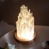 Selenite night light lamp by Conscious Items, weighing 2 pounds, featuring a smooth, translucent white crystal designed for healing and ambiance.
