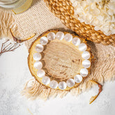 Conscious Items Cleansing Bracelet with natural stone beads on a sleek cord, designed for spiritual and aesthetic appeal.