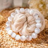 Conscious Items The Cleansing Bracelet featuring sleek black beads and a silver charm on a delicate chain.