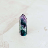 Conscious Items cleansing stone in point and pyramid shapes, made of natural stone, used for skincare or ritual cleansing.