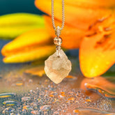 Libyan Desert Glass pendant necklace featuring The Destiny Relic by Conscious Items, showcasing a smooth, amber-colored glass pendant.