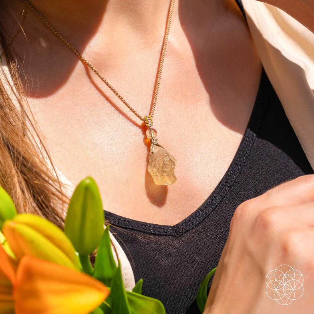 Libyan Desert Glass pendant necklace by Conscious Items featuring a polished, golden-yellow glass relic with intricate details.