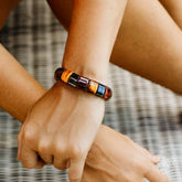Close-up of The Determination Bracelet by Conscious Items, featuring a sleek design with textured metal and an inspirational charm.