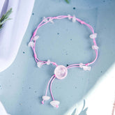 Silver anklet from Conscious Items featuring delicate charms for emotional healing and positive energy.