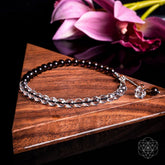 Silver Energy Shield Anklet by Conscious Items featuring a delicate chain and charm, worn around the ankle.