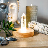 Conscious Items The Healing Lamp night light emitting a soft glow, designed for a calming and soothing ambiance in a bedroom or living space.