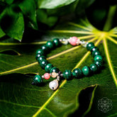 Close-up of the Conscious Items Law of Attraction Bracelet featuring engraved charms and adjustable cord on a neutral background.