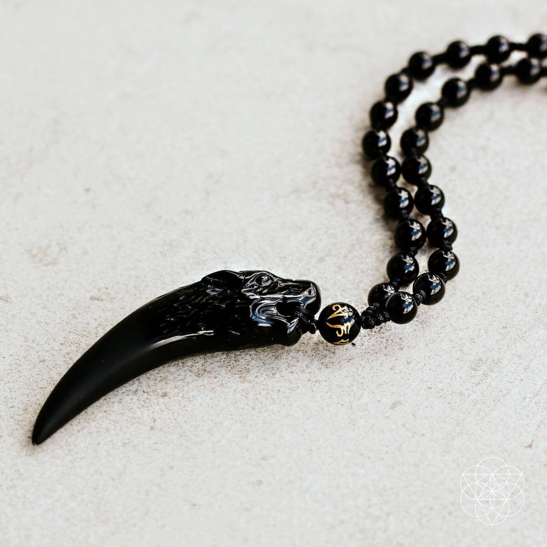 Black obsidian wolf pendant necklace by Conscious Items, featuring a detailed wolf design on a sleek chain.