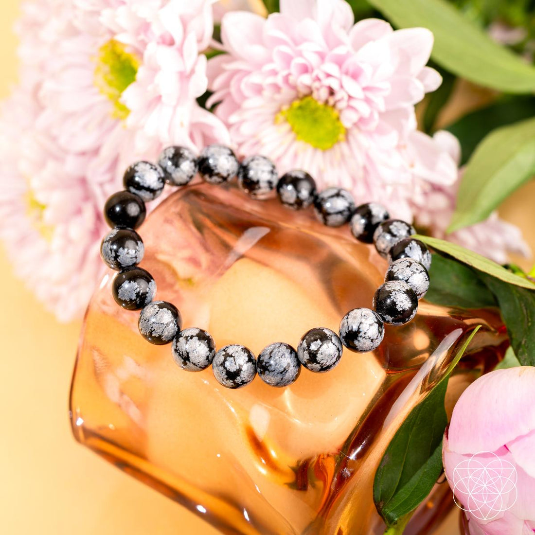 Snowflake Obsidian bracelet by Conscious Items featuring black and white patterned stones on a stretchy cord.