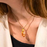 Gold Prosperity Pendant necklace by Conscious Items featuring a sleek, minimalist design with a symbolic charm for positive energy.