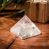 Decorative pyramids of power for home decor by Conscious Items, featuring geometric stone structures on a wooden surface.