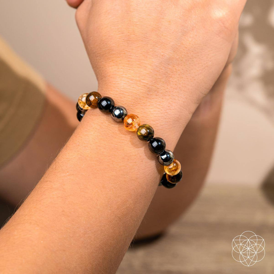 Conscious Items Quadruple Protection Bracelet featuring layered black cord design with metal accents and adjustable closure.
