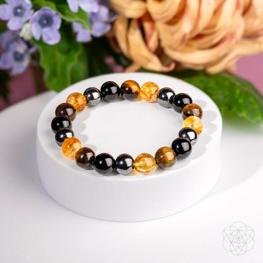 Conscious Items quadruple protection bracelet with layered beaded design and adjustable closure on a white background.