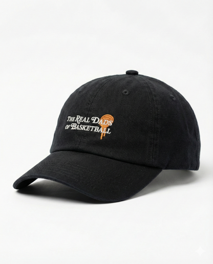 Black and orange Real Dads basketball cap with curved brim and embroidered logo, stylish and sporty headwear for men.