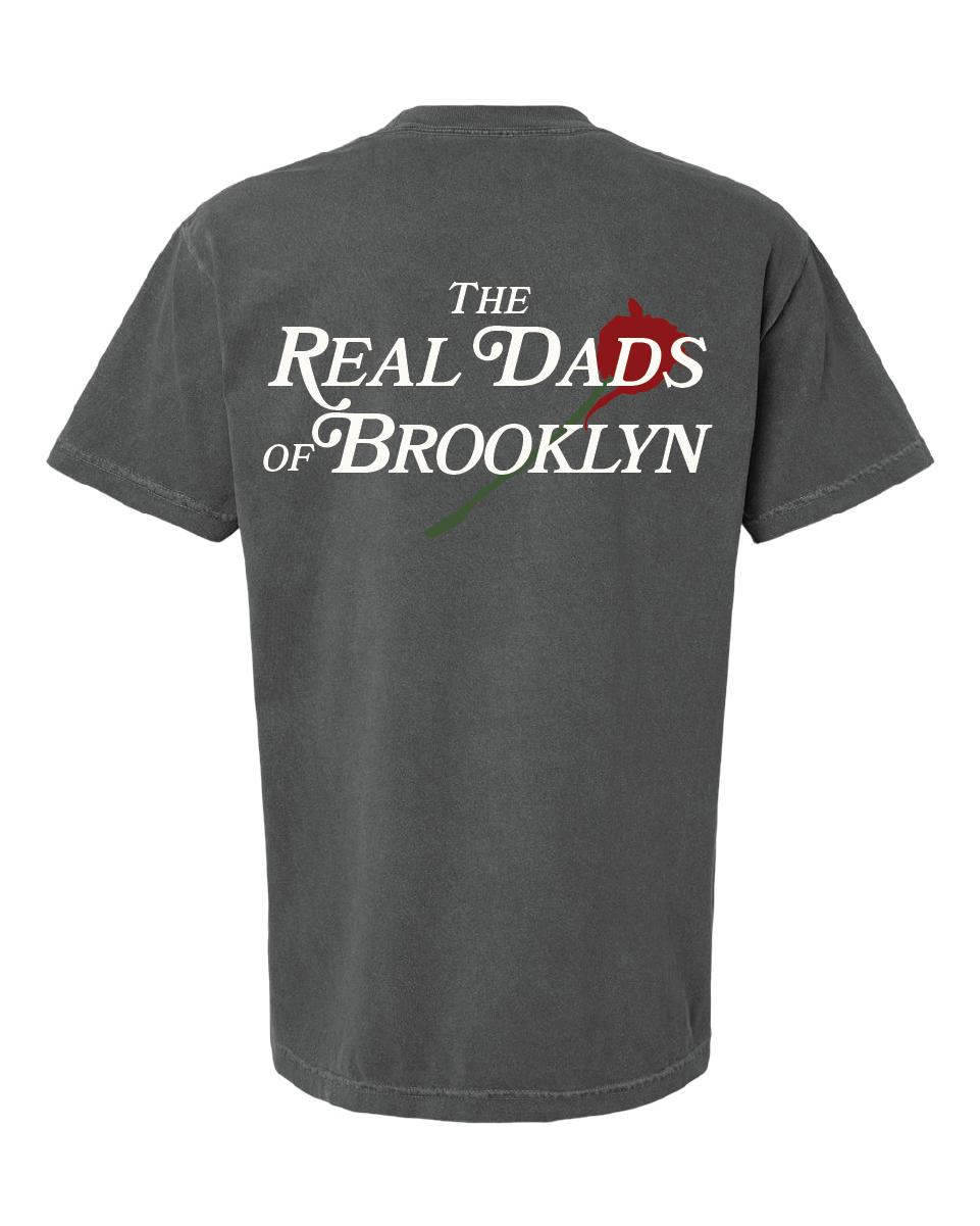 Faded grey RDOB T-shirt by The Real Dads, featuring a casual fit and soft cotton fabric, displayed on a hanger.