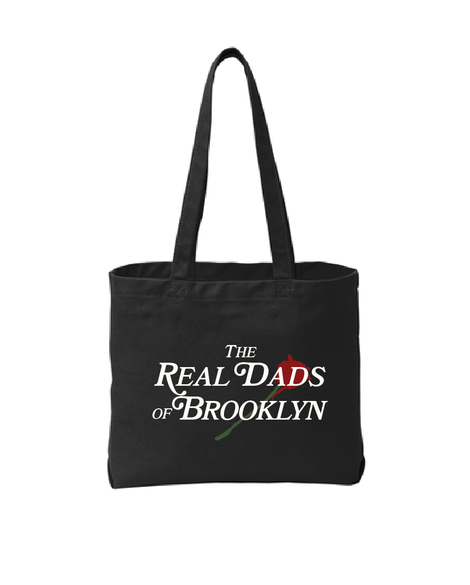 Black RDOB Tote bag by The Real Dads, showing a spacious fabric tote with sturdy handles and minimalist design.