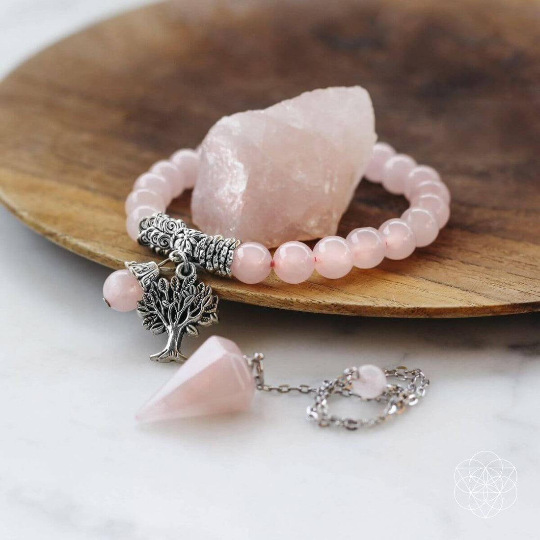 Rose quartz healing crystal jewelry set featuring pendants, bracelets, and earrings with polished pink stones from Conscious Items.