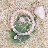 Rose quartz healing crystal jewelry set by Conscious Items featuring pink gemstone necklaces, bracelets, and earrings.