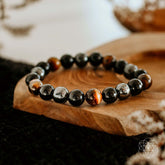 Conscious Items Triple Protection Bracelet featuring three layered bands with beads and charms on a neutral background.