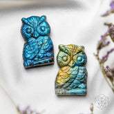 Labradorite owl-shaped crystal heart talisman from Conscious Items, featuring a polished stone with iridescent blue and green hues.