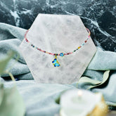 Tourmaline anklet of hope by Conscious Items featuring colorful gemstone beads and delicate silver chain on a white background.
