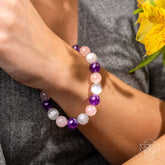 Conscious Items Trinity Bracelet of Stress Resilience featuring colorful beads and a meditative charm for stress relief and resilience.