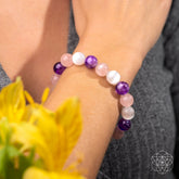 Conscious Items Trinity Bracelet of Stress Resilience featuring intertwined metal and bead design on a neutral background.