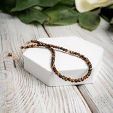 Conscious Items triple protection anklet set featuring three delicate silver anklets with protective charms, on a neutral background.