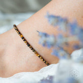 Conscious Items triple protection anklet set featuring three delicate silver anklets with intricate designs on a white background.