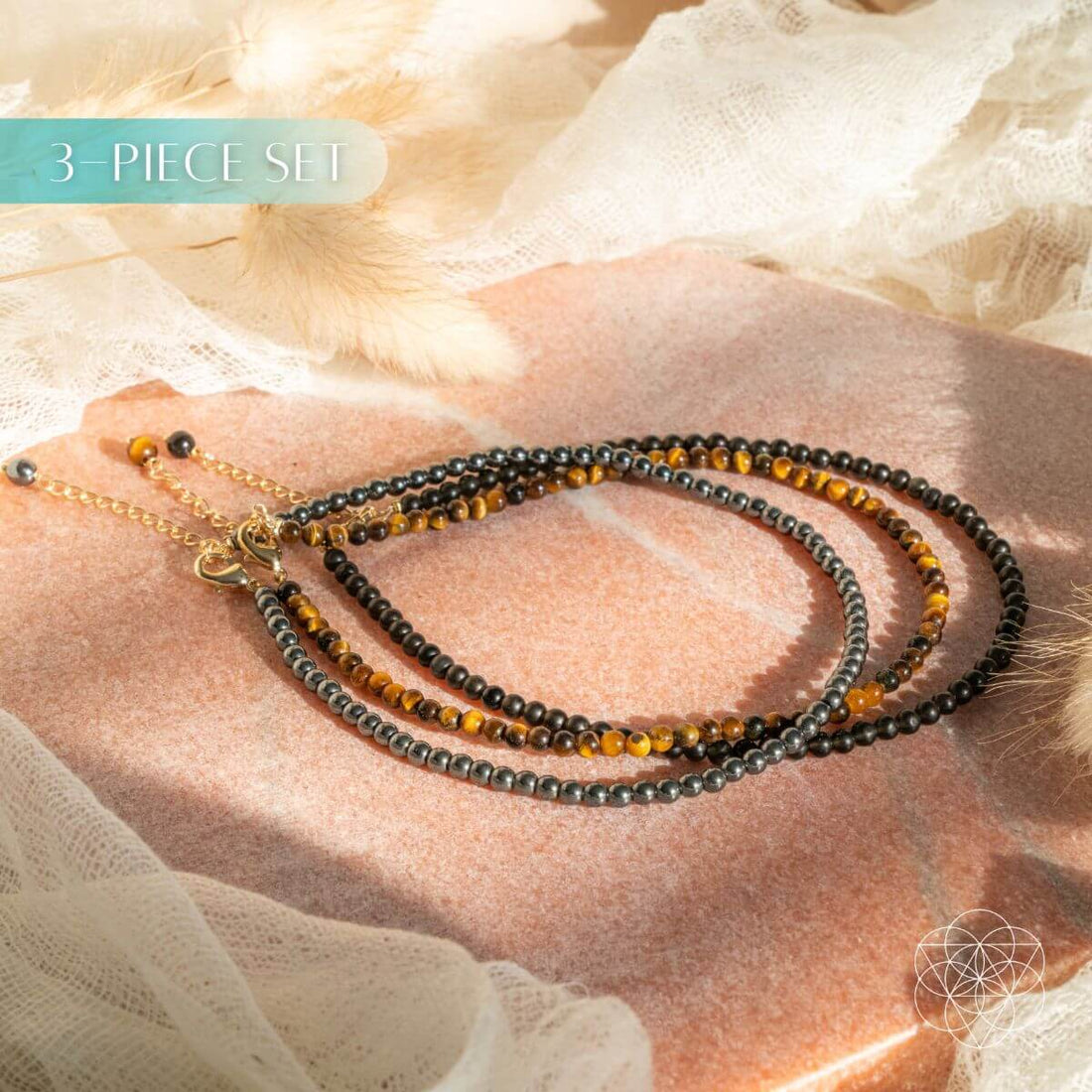 Conscious Items triple protection anklet set featuring three layered silver anklets with intricate designs on a white background.