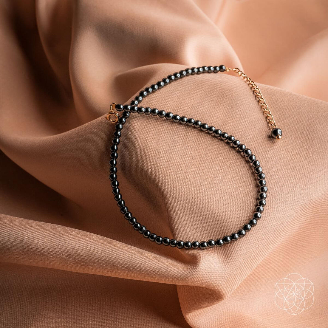 Conscious Items triple protection anklet set featuring three delicate silver anklets with protective charms and intricate designs.