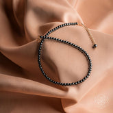 Conscious Items triple protection anklet set featuring three delicate silver anklets with protective charms and intricate designs.