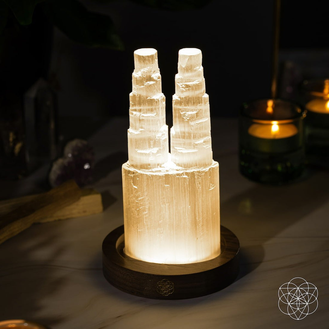 Two-tower Selenite lamp night light by Conscious Items with deep energy cleansing and reset features, glowing softly.