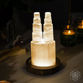 Two-tower Selenite lamp night light by Conscious Items with deep energy cleansing and reset features, glowing softly.
