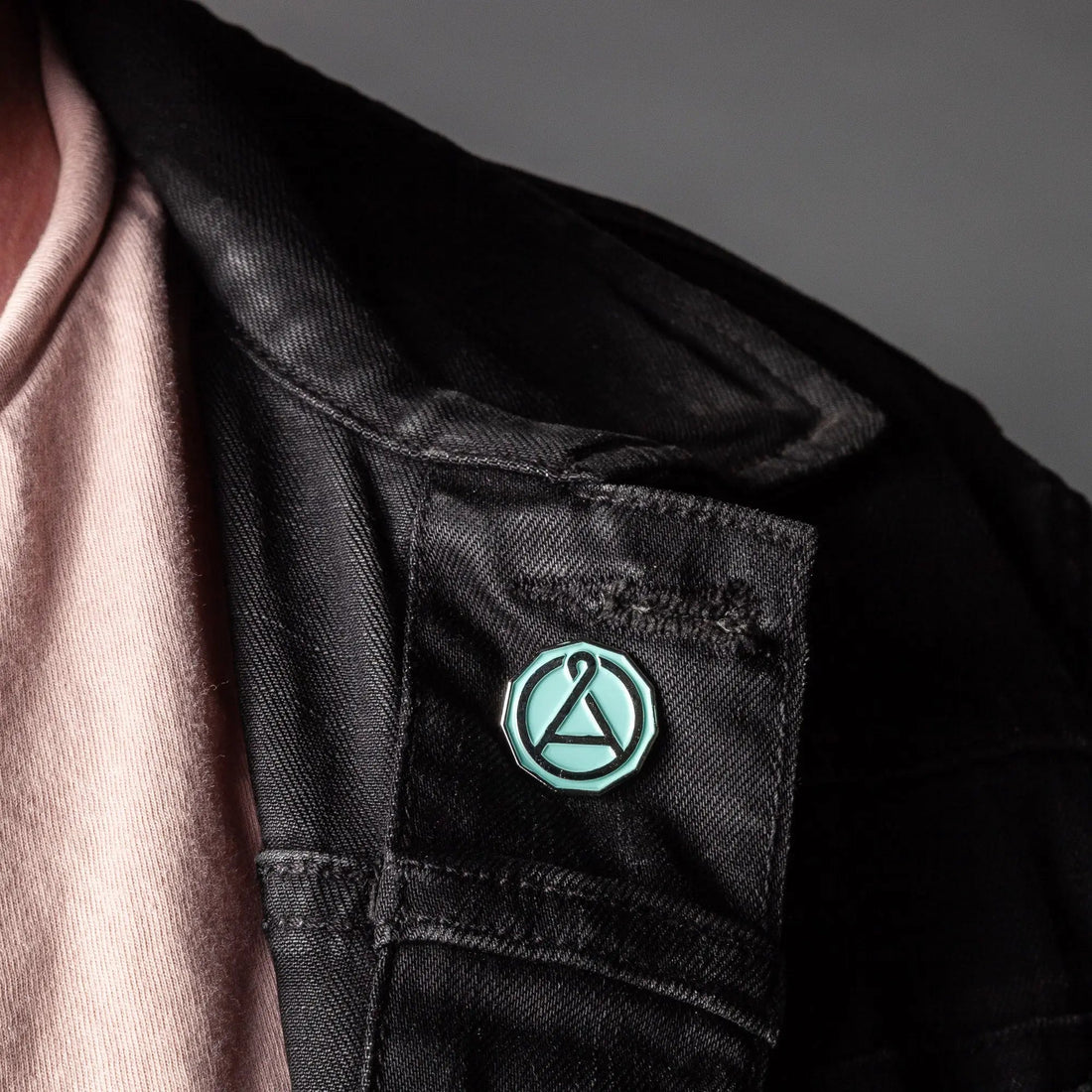 August Seal enamel pin from August Uncommon Tea swag collection, featuring a colorful seal design on a metal pin.