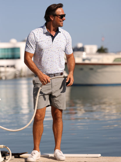 Gray White Water Life Links Print Polo shirt displayed on a hanger, showcasing the casual polo design and print details.