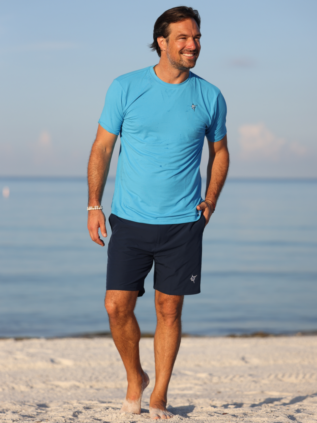 White Water Life Grander Short Sleeve Performance Tee, lightweight athletic shirt with moisture-wicking fabric, shown on a hanger.