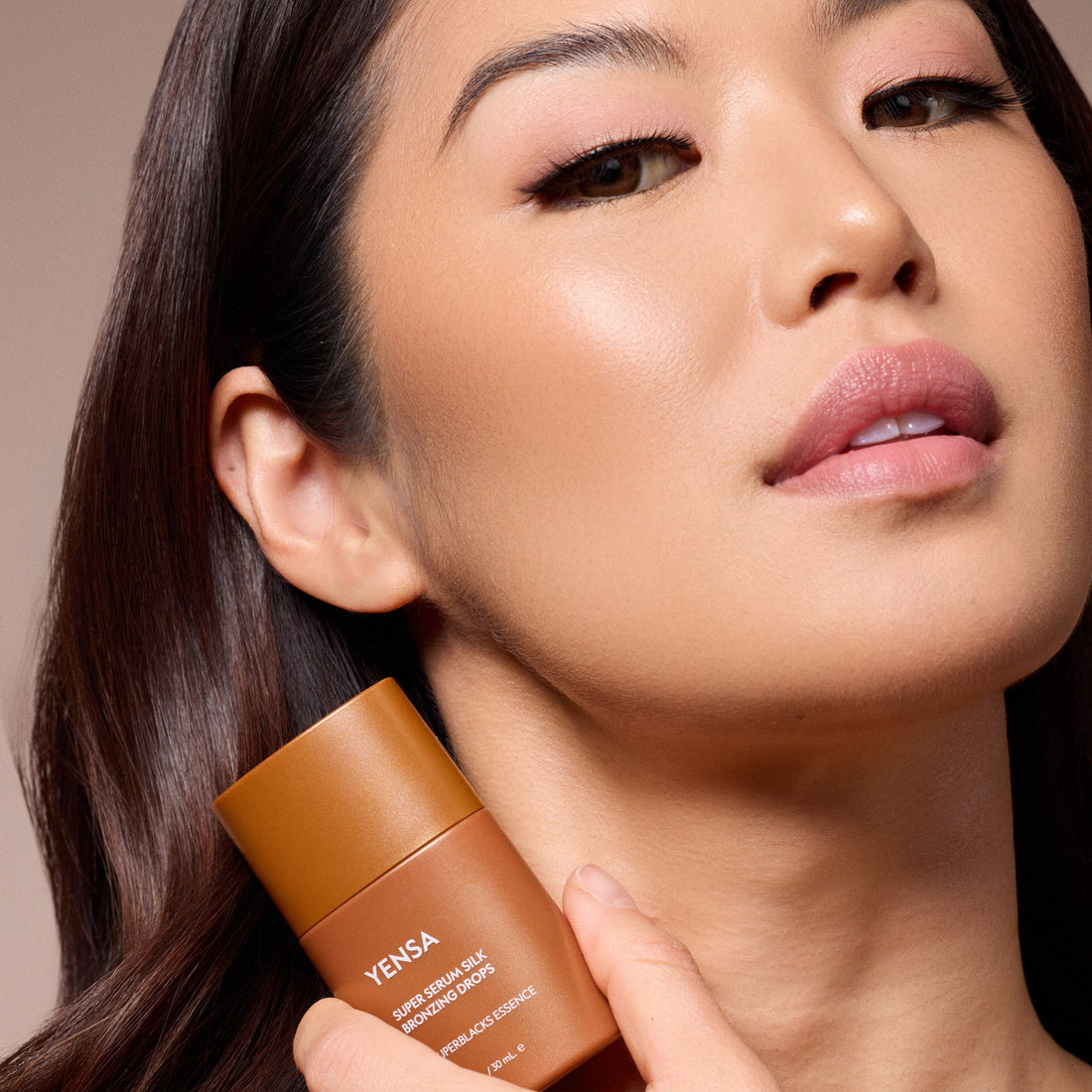 YENSA Super Serum Silk Bronzing Drops in a clear bottle with a dropper, showcasing the liquid bronzer for a natural sun-kissed glow.