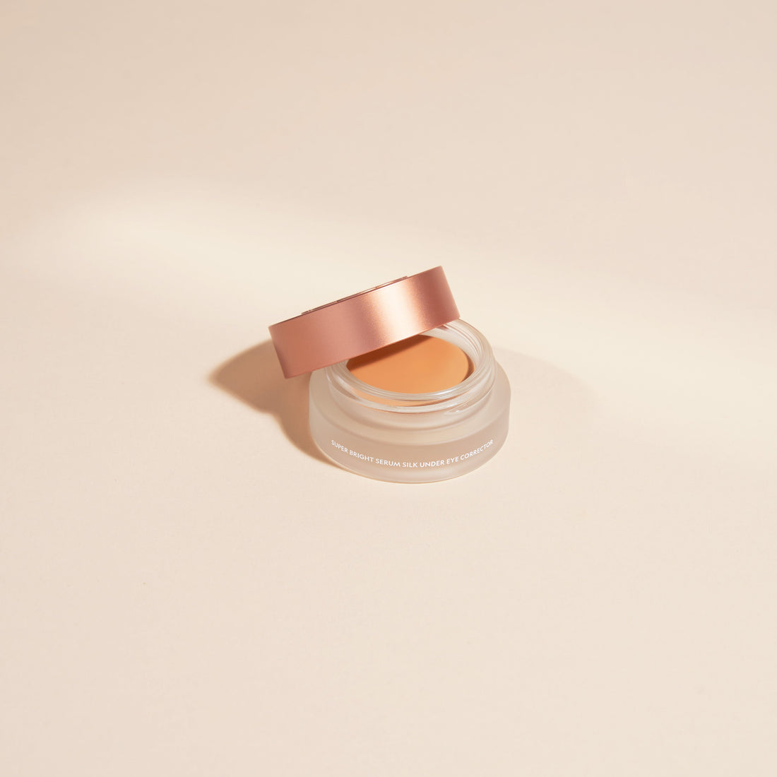 YENSA Super Bright Dark Circle Serum Eye Corrector in medium shade, with a sleek tube and applicator for reducing dark circles and puffiness.