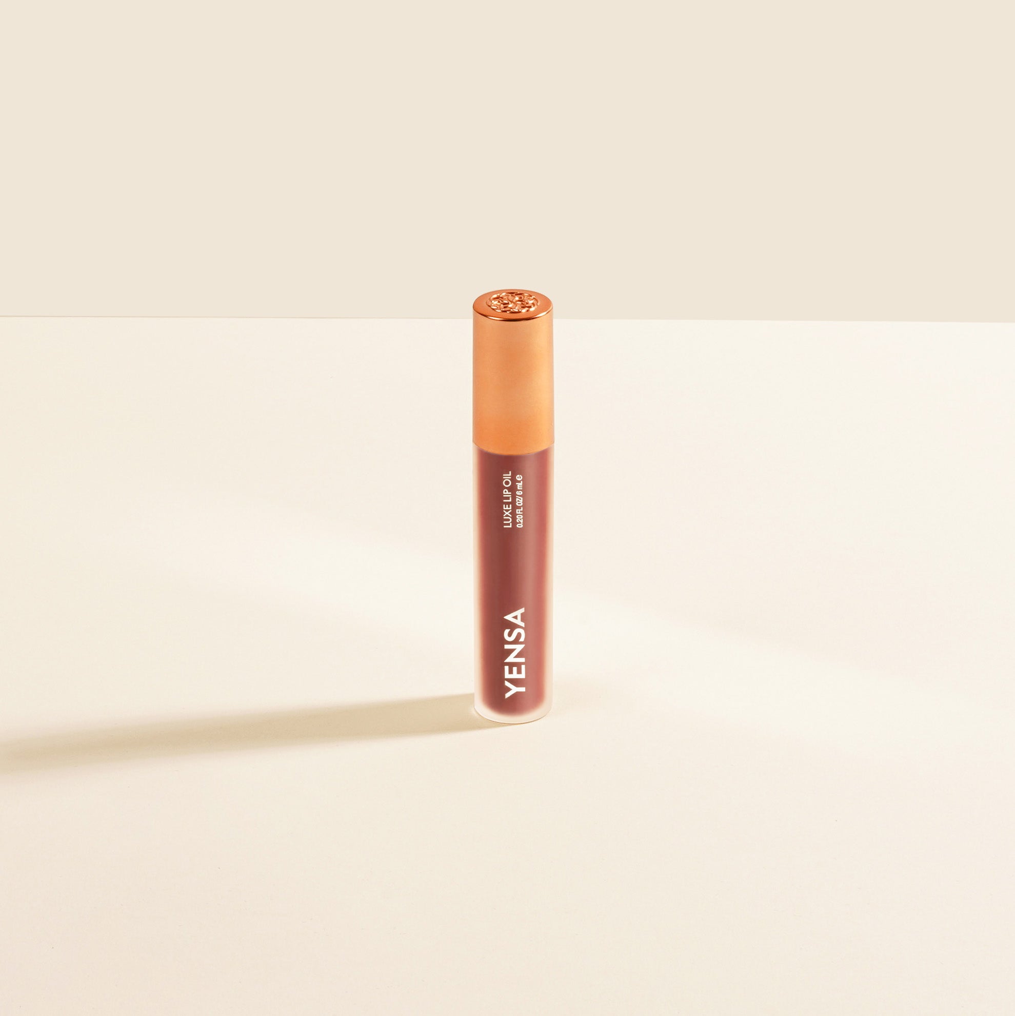 YENSA Luxe Lip Nourishing Oil with hyaluronic and vitamin E, featuring a modern nude lip oil applicator and sleek packaging.