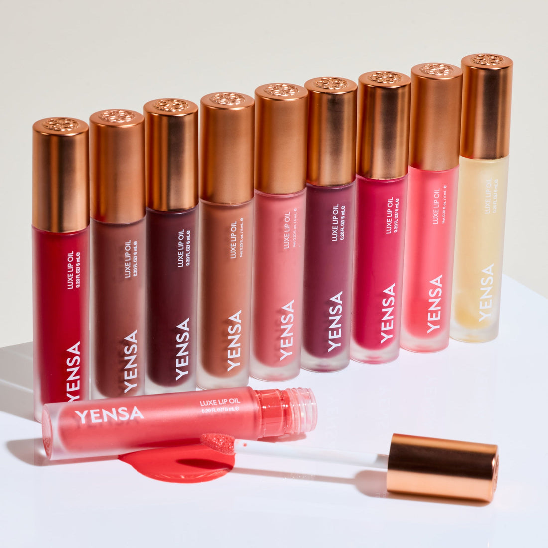 YENSA Luxe Lip Nourishing Oil with hyaluronic acid and vitamin E, featuring a clear lip oil applicator and glossy finish.