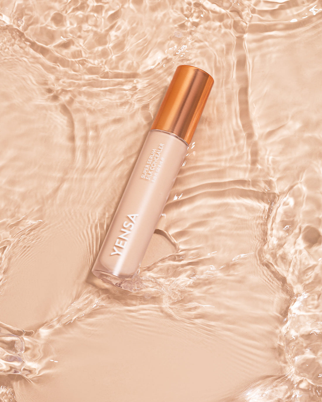 YENSA Super Serum Silk Concealer applied under eyes and on skin, showcasing smooth, flawless makeup finish.